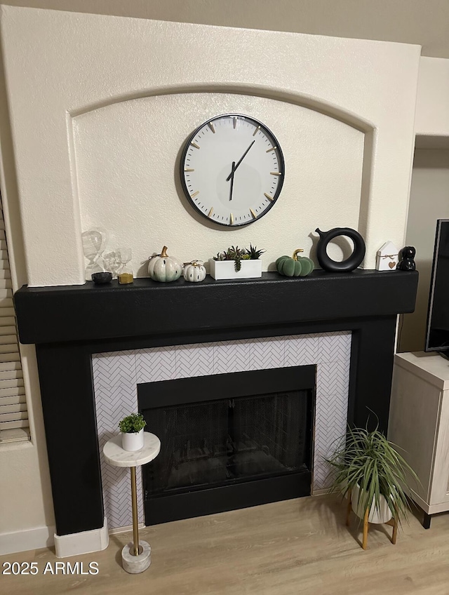 8673 W Palm Ln, Phoenix, AZ 85037 - detailed view of a tiled fireplace and wood finished floors