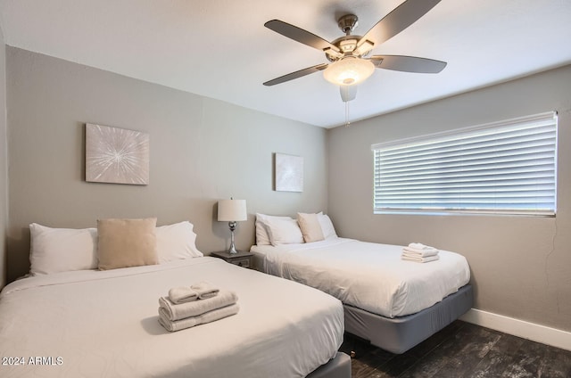 bedroom featuring ceiling fan and dark hardwood / wood-style flooring