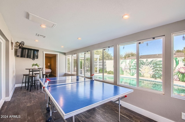 rec room with plenty of natural light and dark hardwood / wood-style floors