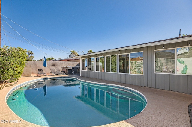 view of swimming pool with a patio area