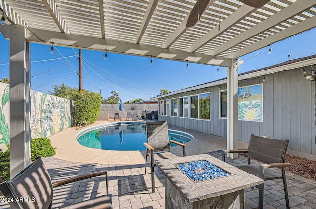 view of pool featuring a patio and a fire pit