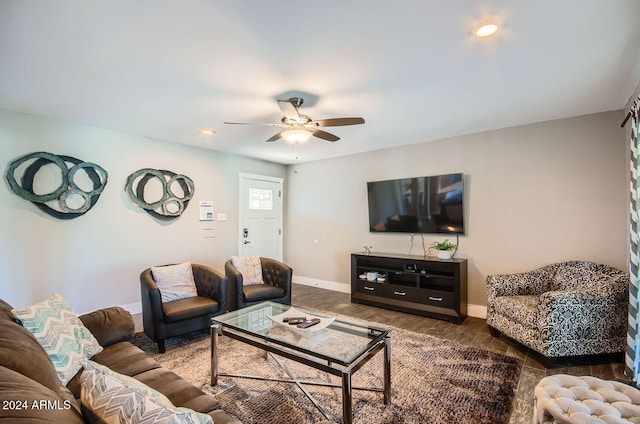 living room with ceiling fan and dark wood-type flooring