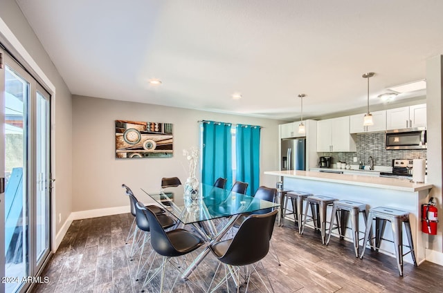 dining room featuring dark hardwood / wood-style flooring and sink