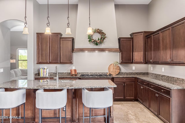2255 N Hillridge, Mesa, AZ 85207 - kitchen with a sink, light stone countertops, a kitchen breakfast bar, and stainless steel gas stovetop
