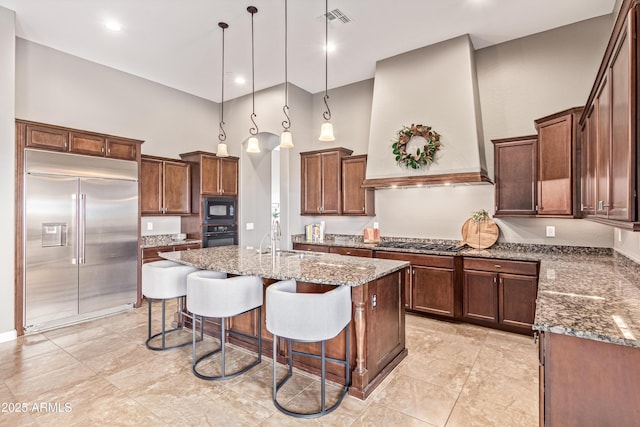 2255 N Hillridge, Mesa, AZ 85207 - kitchen featuring black appliances, a towering ceiling, custom exhaust hood, stone counters, and a kitchen island with sink