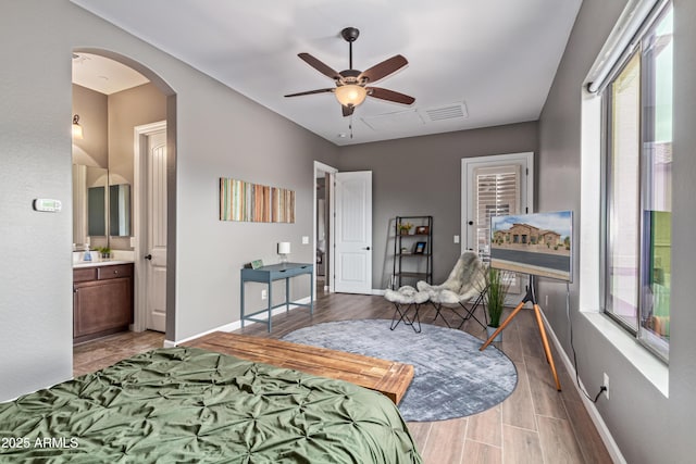 2255 N Hillridge, Mesa, AZ 85207 - bedroom with multiple windows, baseboards, arched walkways, and light wood finished floors