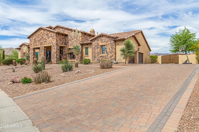 2255 N Hillridge, Mesa, AZ 85207 - view of front of home featuring stone siding, a gate, a tiled roof, and stucco siding