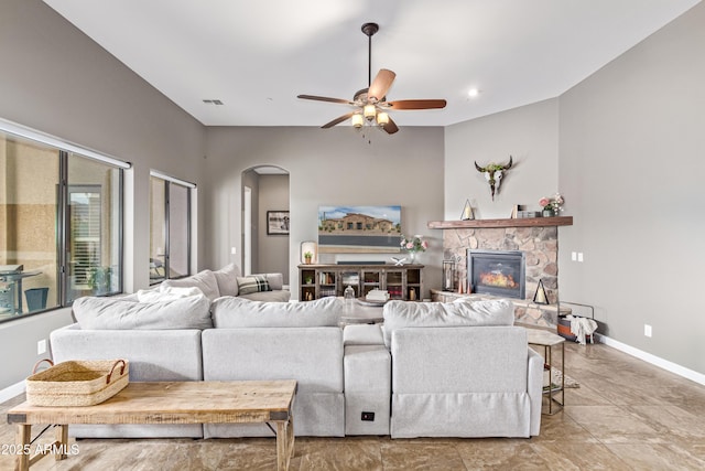 2255 N Hillridge, Mesa, AZ 85207 - living area featuring arched walkways, ceiling fan, a stone fireplace, and baseboards