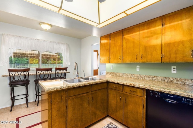 kitchen featuring kitchen peninsula, light tile patterned floors, black dishwasher, and sink