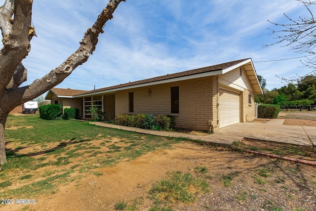 exterior space with a yard and a garage