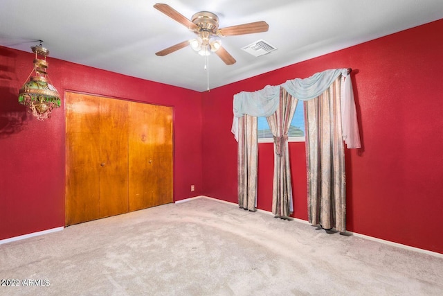 unfurnished room featuring carpet flooring and ceiling fan