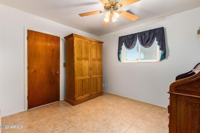 unfurnished bedroom with ceiling fan and light tile patterned flooring