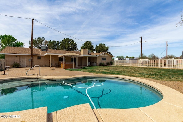 view of swimming pool with a lawn, a jacuzzi, and a patio