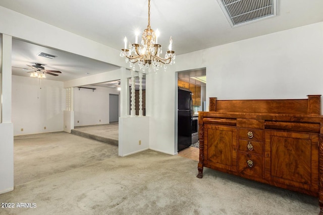 carpeted empty room with ceiling fan with notable chandelier