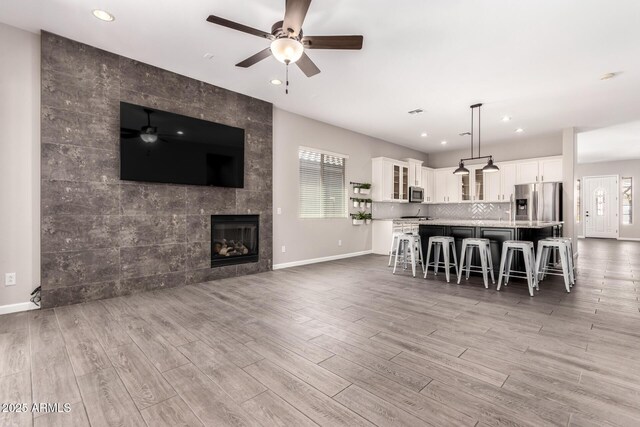 2409 W Red Range Way, Phoenix, AZ 85085 - living area with a ceiling fan, wood finished floors, baseboards, plenty of natural light, and recessed lighting