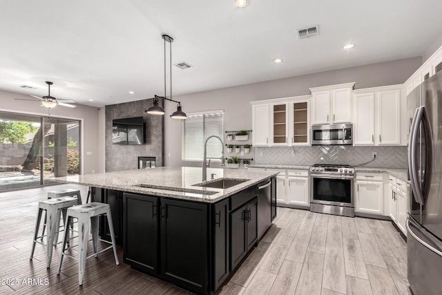 2409 W Red Range Way, Phoenix, AZ 85085 - kitchen with appliances with stainless steel finishes, a sink, white cabinetry, and recessed lighting