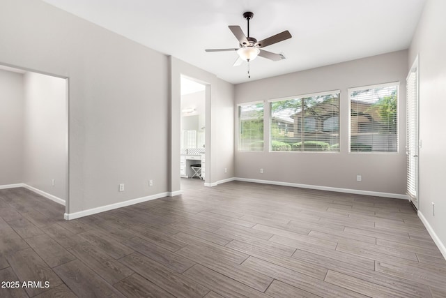 2409 W Red Range Way, Phoenix, AZ 85085 - empty room featuring a ceiling fan, dark wood-type flooring, and baseboards