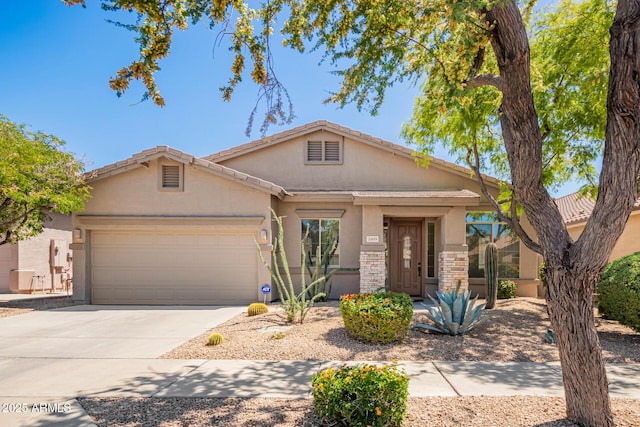 2409 W Red Range Way, Phoenix, AZ 85085 - view of front of home with stucco siding, an attached garage, and driveway
