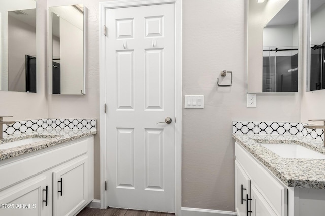 2409 W Red Range Way, Phoenix, AZ 85085 - bathroom featuring two vanities, baseboards, and wood finished floors