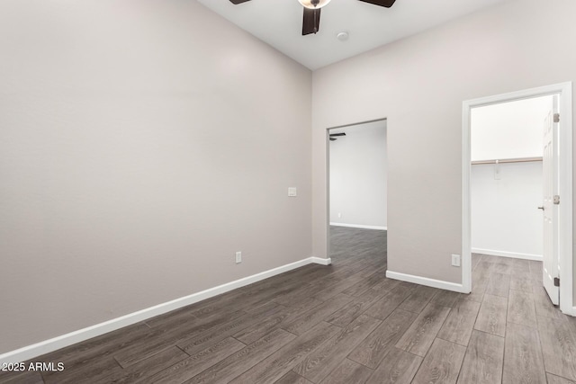 2409 W Red Range Way, Phoenix, AZ 85085 - unfurnished bedroom with wood finished floors, a spacious closet, baseboards, a closet, and a ceiling fan