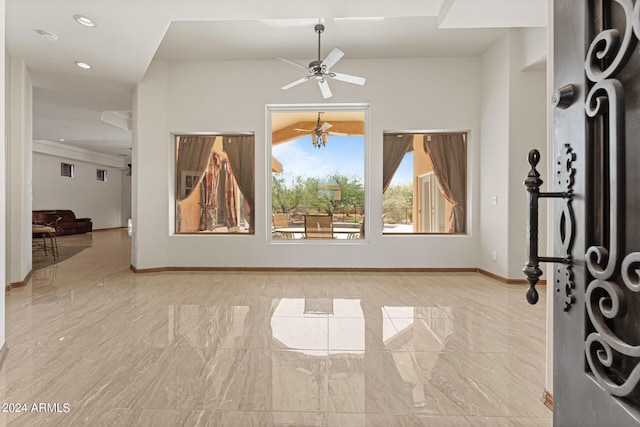 interior space with ceiling fan