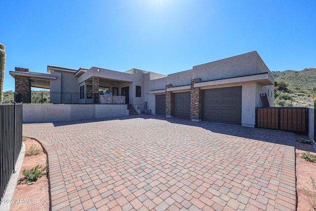 14914 E Zapata Dr, Fountain Hills, AZ 85268 - view of front of house featuring stucco siding, an attached garage, decorative driveway, and fence