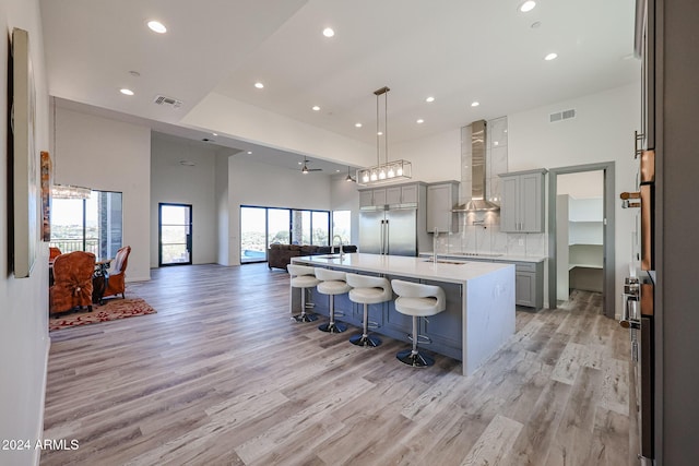 14914 E Zapata Dr, Fountain Hills, AZ 85268 - kitchen with built in refrigerator, wall chimney exhaust hood, gray cabinets, recessed lighting, and a towering ceiling