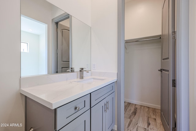 bathroom with vanity and hardwood / wood-style flooring