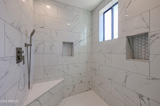 bathroom with tiled shower