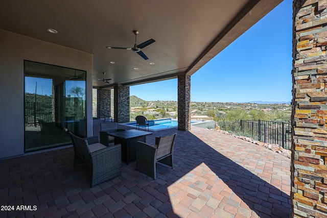 view of patio featuring ceiling fan and a fenced in pool