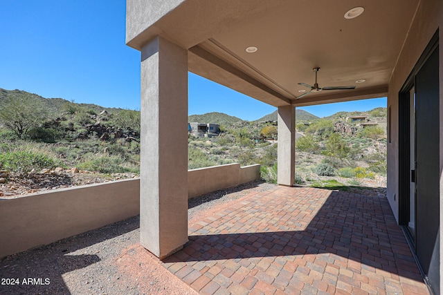 view of patio with a mountain view and ceiling fan