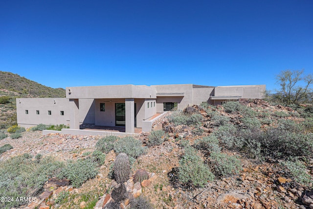 rear view of house featuring a patio area and a mountain view