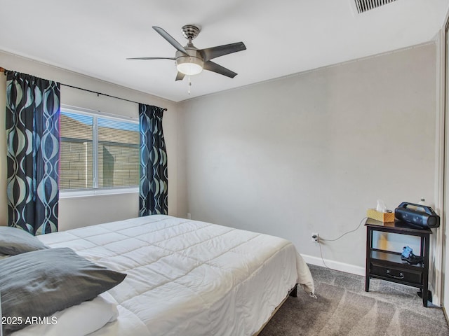 bedroom with a ceiling fan, carpet flooring, and baseboards