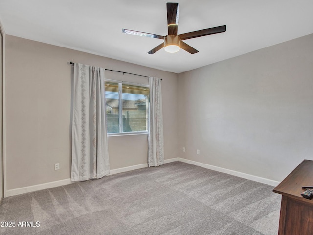 unfurnished room featuring light carpet, ceiling fan, and baseboards