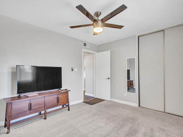 bedroom featuring light carpet, a closet, visible vents, and baseboards