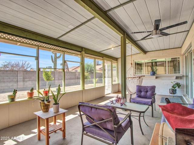 sunroom / solarium with a ceiling fan