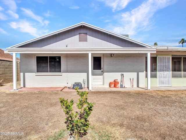 rear view of house with a yard