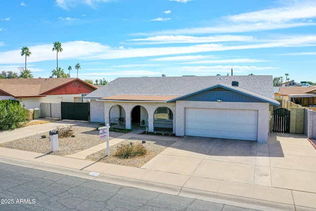 ranch-style house featuring a garage, concrete driveway, roof with shingles, fence, and stucco siding