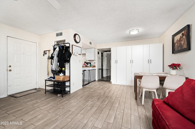 interior space with light hardwood / wood-style flooring and a textured ceiling