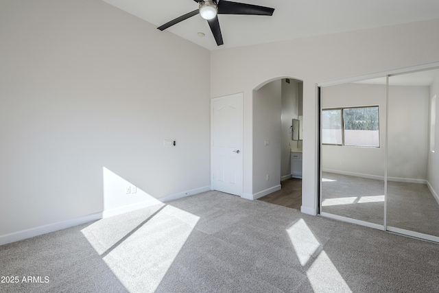 unfurnished bedroom with carpet, ceiling fan, and a closet