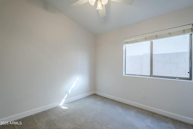 carpeted empty room featuring ceiling fan and lofted ceiling