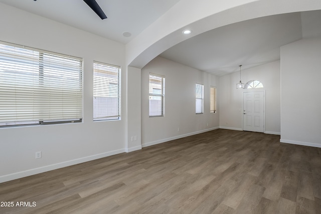 foyer entrance with hardwood / wood-style flooring and vaulted ceiling