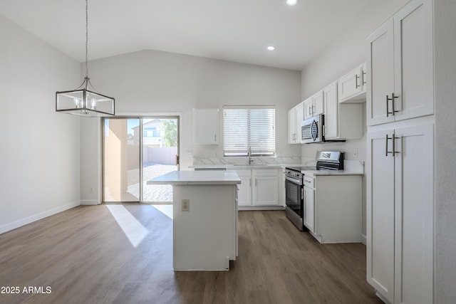 kitchen with white cabinetry, a center island, sink, stainless steel appliances, and decorative light fixtures