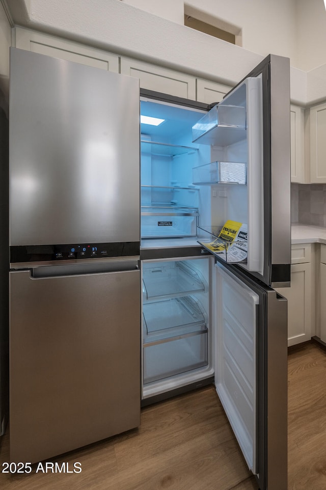 866 W Geronimo St, Chandler, AZ 85225 - kitchen with freestanding refrigerator, wood finished floors, white cabinets, and backsplash