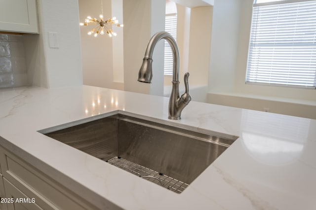 866 W Geronimo St, Chandler, AZ 85225 - kitchen view of a chandelier, a sink, and light stone counters
