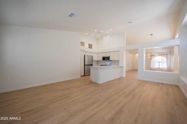 866 W Geronimo St, Chandler, AZ 85225 - unfurnished living room with a chandelier, light wood-style floors, recessed lighting, baseboards, and high vaulted ceiling