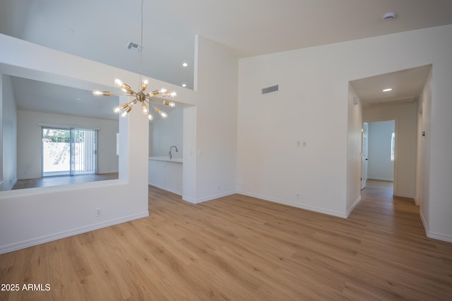 866 W Geronimo St, Chandler, AZ 85225 - unfurnished room featuring a chandelier, light wood-style flooring, baseboards, and recessed lighting