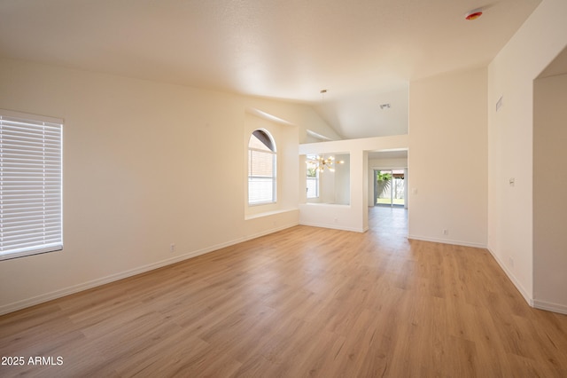 866 W Geronimo St, Chandler, AZ 85225 - empty room featuring a chandelier, light wood-style floors, baseboards, and vaulted ceiling