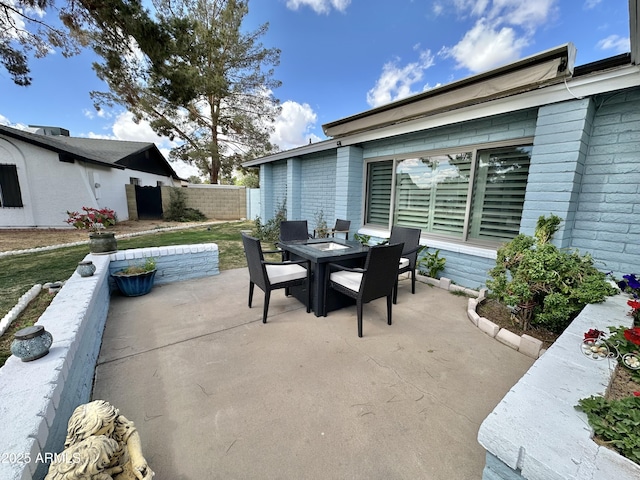 view of patio featuring outdoor dining area and fence