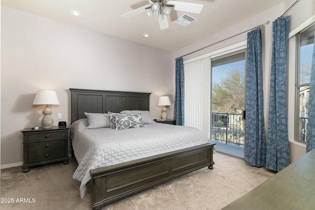 bedroom featuring multiple windows, access to outside, and light colored carpet